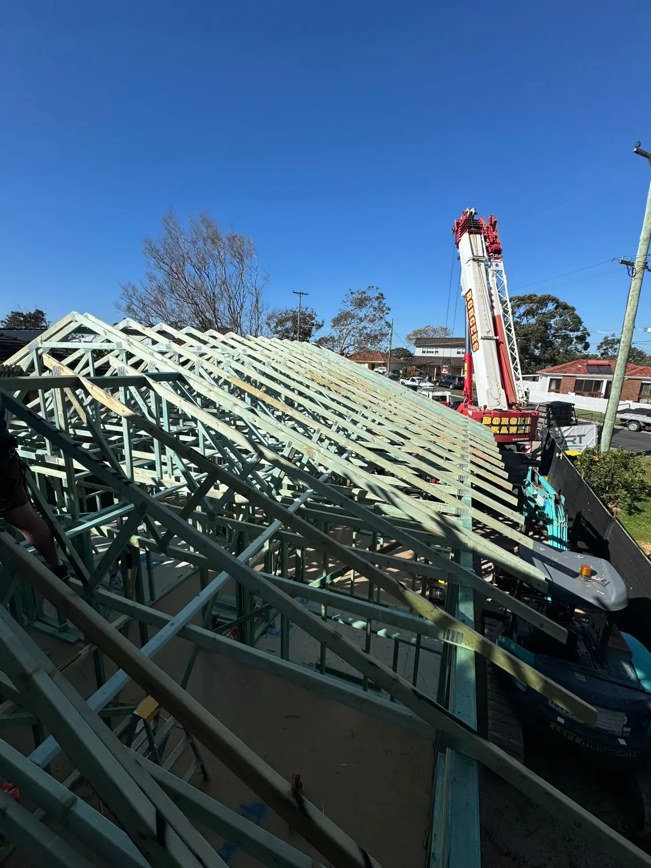 Crane and installed timber roof trusses on a residential build