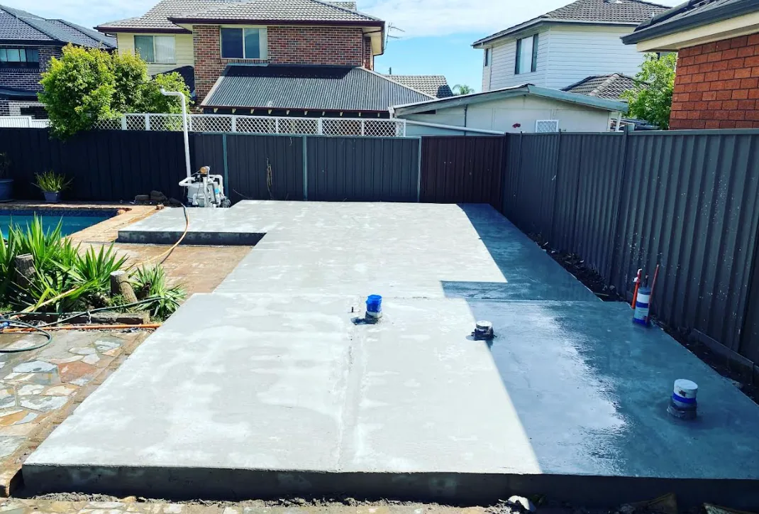 Concrete surround poured and finished around an inground pool