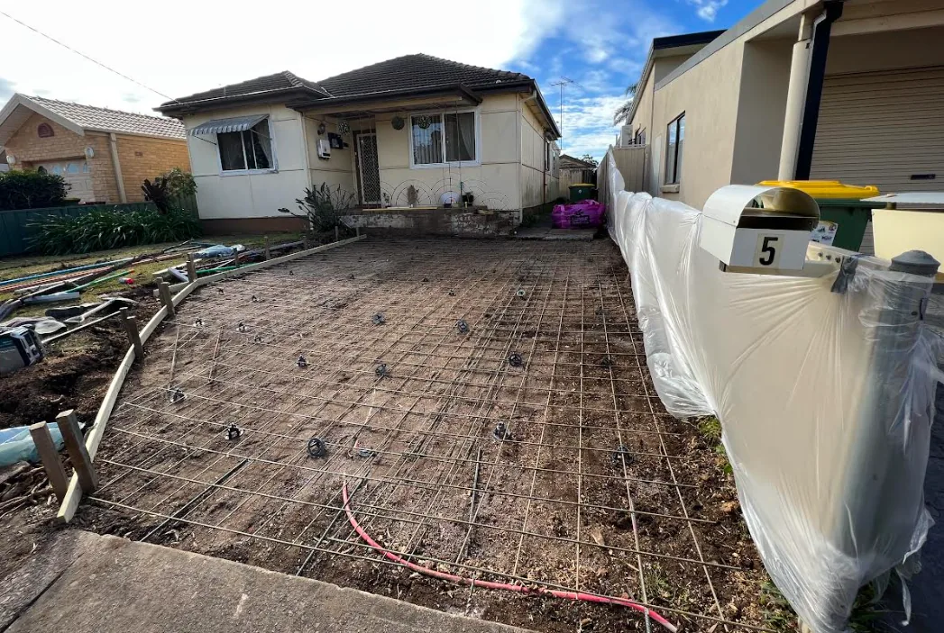 Excavated base with reinforcement set out ahead of a concrete pour
