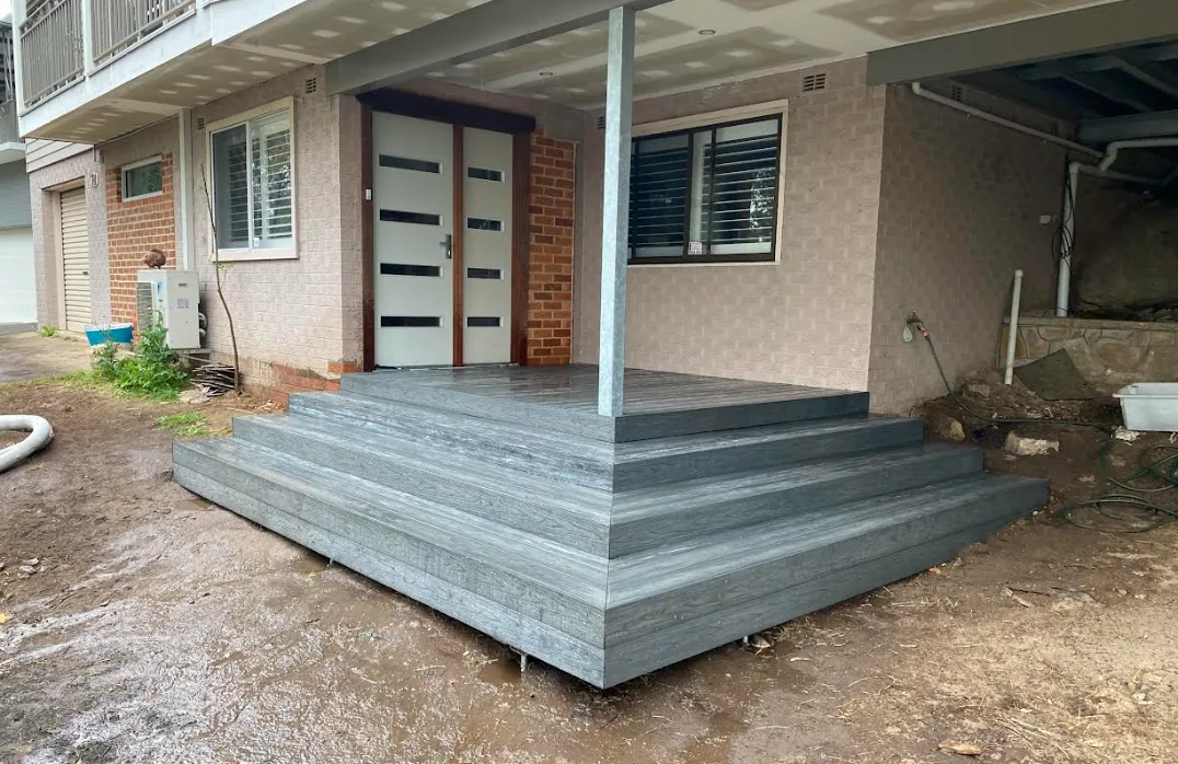 Composite decked landing and steps at the entry of a home
