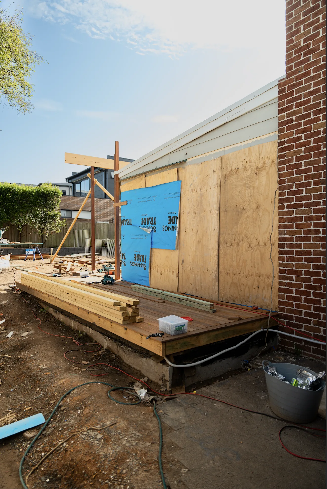 Timber deck frame set out and levelled against the rear wall of the house