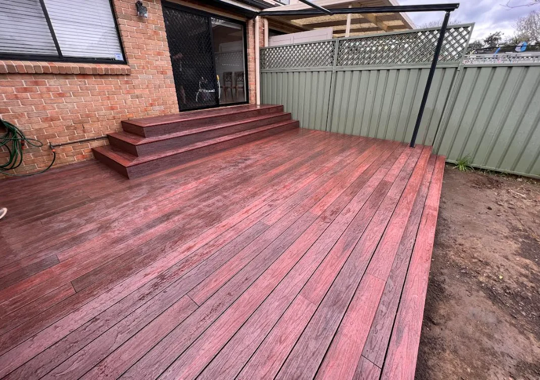 Hardwood rear deck with steps up to the back entry of the home