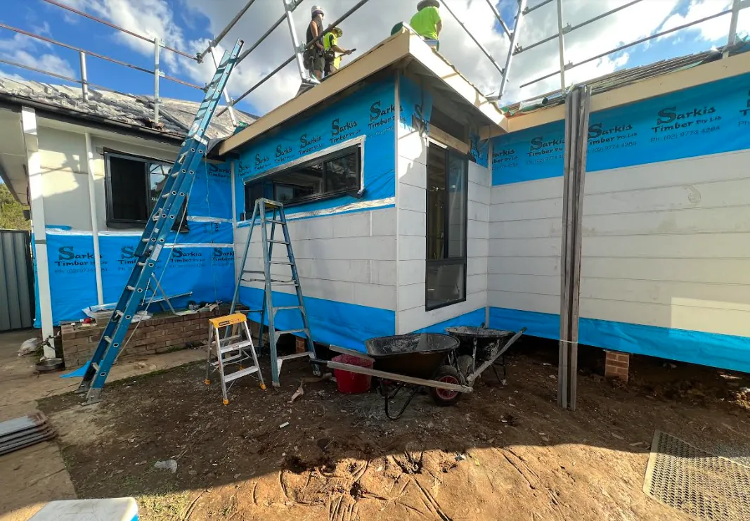 Home extension at Werrington under construction with new cladding, wrap and scaffolding in place