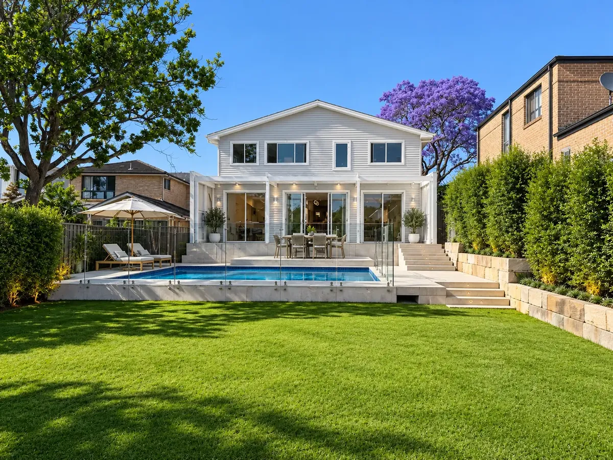 Completed rear of the Gymea Bay home with alfresco area, glass-fenced pool and landscaped lawn