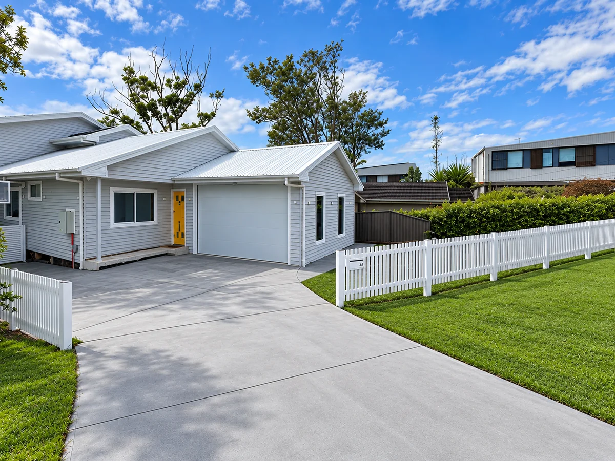 Completed modern home at Gymea Bay with white picket fence, concrete driveway and landscaped frontage