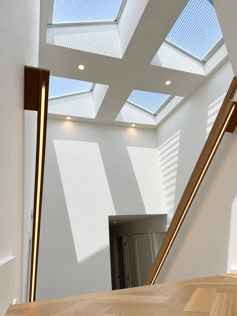Statement timber staircase with integrated LED handrails and overhead skylights at Gymea Bay