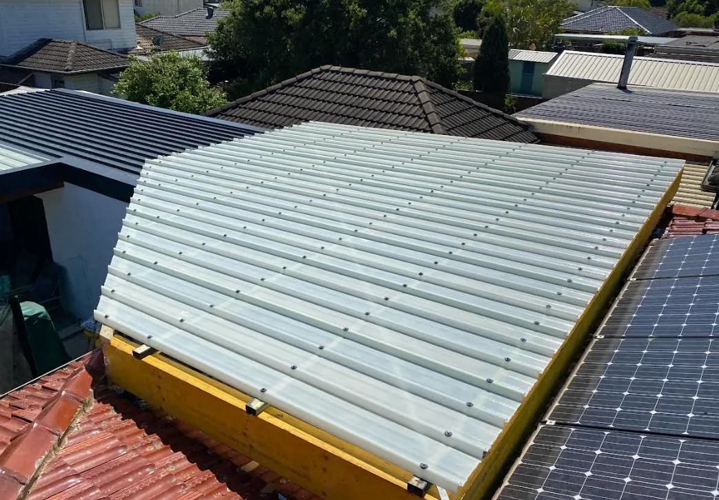 Roof sheeting being fixed to a new patio structure