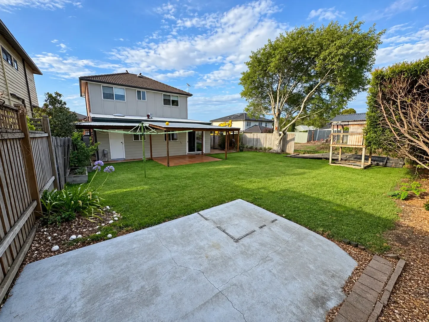 Wide rear yard view showing the new deck, pergola and concrete patio slab at Russell Lea